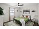 Bright bedroom featuring a large window, neutral walls, hardwood floors, ceiling fan, and modern lighting at 2250 64Th N St, St Petersburg, FL 33710