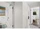 Hallway view to rooms featuring neutral walls and contrasting dark-colored door hardware and flooring at 2250 64Th N St, St Petersburg, FL 33710