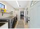 Bright laundry room with modern washer and dryer, utility sink, and access to the main house at 2250 64Th N St, St Petersburg, FL 33710