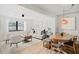 Bright living room with modern furnishings and a view of lush greenery through a large window at 2250 64Th N St, St Petersburg, FL 33710