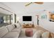 Cozy living room featuring hardwood floors, a large window, and a view to the kitchen at 2250 64Th N St, St Petersburg, FL 33710