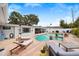 Backyard pool with brick patio, lounge chairs, and nearby outdoor seating space at 2250 64Th N St, St Petersburg, FL 33710