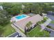 Aerial view highlighting the community pool, clubhouse, and landscaped grounds at 2537 Oakleaf Ln # 32A, Clearwater, FL 33763