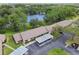 Aerial view showcasing the community, with pond, attached garages, landscaping and green spaces at 2537 Oakleaf Ln # 32A, Clearwater, FL 33763