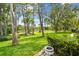 Beautiful backyard with lush landscaping, mature trees, and scenic lakefront views at 2537 Oakleaf Ln # 32A, Clearwater, FL 33763