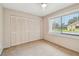 Cozy bedroom with plush carpeting, neutral walls, and a window providing natural light at 2537 Oakleaf Ln # 32A, Clearwater, FL 33763