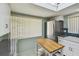 Bright kitchen with stainless steel refrigerator, white cabinetry, and a butcher block island at 2537 Oakleaf Ln # 32A, Clearwater, FL 33763