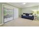 Bright living room with a comfortable blue couch and sliding glass doors to the lanai at 2537 Oakleaf Ln # 32A, Clearwater, FL 33763