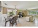 Open living space features tile flooring, large windows, and dining area with pendant lighting at 2537 Oakleaf Ln # 32A, Clearwater, FL 33763