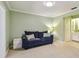 Inviting living room features a stylish blue sofa, side table, and a view of the bathroom at 2537 Oakleaf Ln # 32A, Clearwater, FL 33763