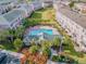 Aerial view of community pool, clubhouse, well-manicured lawns and rows of condo buildings at 2547 Lexington Oak Dr, Brandon, FL 33511
