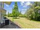 Spacious backyard, perfect for outdoor activities and relaxation, enhanced by mature landscaping at 2547 Lexington Oak Dr, Brandon, FL 33511