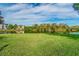 Expansive grass lawn overlooking the lake with trees and condo buildings in the background at 2547 Lexington Oak Dr, Brandon, FL 33511