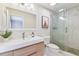Modern bathroom with stylish vanity, elegant mirror, and glass-enclosed shower with pebble accents at 2547 Lexington Oak Dr, Brandon, FL 33511