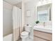 Cozy bathroom with neutral walls, white sink, and bathtub with shower curtain at 2547 Lexington Oak Dr, Brandon, FL 33511