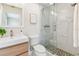 Modern bathroom featuring a glass door shower, a light wood sink, and bright lighting at 2547 Lexington Oak Dr, Brandon, FL 33511