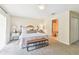 Inviting bedroom featuring carpeted floors, a decorative bed, and a bathroom entrance at 2547 Lexington Oak Dr, Brandon, FL 33511