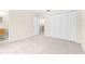 Neutral bedroom featuring carpet flooring, an open door and closet doors at 2547 Lexington Oak Dr, Brandon, FL 33511