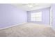 Spacious bedroom with soft carpet and a large window at 2547 Lexington Oak Dr, Brandon, FL 33511