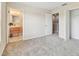 Inviting bedroom showcasing neutral walls, carpet floors, and an en suite bathroom with a walk-in closet at 2547 Lexington Oak Dr, Brandon, FL 33511