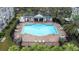 Aerial view of community pool area with lounge chairs, tables, and lush landscaping at 2547 Lexington Oak Dr, Brandon, FL 33511