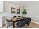 Dining area with a dark wood table, seating for six, modern chandelier, and stylish wall decor at 2547 Lexington Oak Dr, Brandon, FL 33511