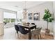 Dining area featuring a dark wood table with seating for six and modern chandelier lighting at 2547 Lexington Oak Dr, Brandon, FL 33511