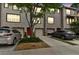 Three-story townhome showcasing a well-maintained exterior with individual garages and a vibrant red front door at 2547 Lexington Oak Dr, Brandon, FL 33511