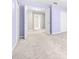 Neutral hallway with open doorways to bedrooms and closets at 2547 Lexington Oak Dr, Brandon, FL 33511