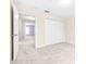 Neutral hallway with an open doorway to a lavender bedroom and multiple doors at 2547 Lexington Oak Dr, Brandon, FL 33511
