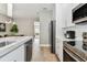Modern kitchen featuring stainless steel appliances, quartz countertops, and hardwood floors at 2547 Lexington Oak Dr, Brandon, FL 33511