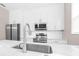 Well-equipped kitchen featuring white cabinets, stainless steel appliances, and a quartz island at 2547 Lexington Oak Dr, Brandon, FL 33511