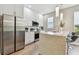 Modern kitchen featuring stainless steel appliances, white cabinetry, and a sleek island with bar seating at 2547 Lexington Oak Dr, Brandon, FL 33511