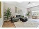 Bright living room featuring modern decor, a comfortable gray sectional sofa, and natural light from a window at 2547 Lexington Oak Dr, Brandon, FL 33511