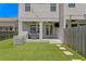 Backyard features a covered patio with a grill, ceiling fans, and turf at 2708 W North B St # 3, Tampa, FL 33609