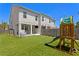 This backyard features lush artificial turf, a wooden playset, and an outdoor grilling area at 2708 W North B St # 3, Tampa, FL 33609