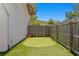 Backyard putting green with a wood fence, turf, and palm trees at 2708 W North B St # 3, Tampa, FL 33609
