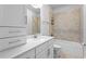 Well-lit bathroom with a single sink vanity, tiled shower, and toilet at 2708 W North B St # 3, Tampa, FL 33609