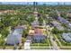 Aerial view of a neighborhood showcasing lush green trees and a charming two-story home at 3008 S Church Ave, Tampa, FL 33629