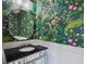 This bathroom has a beautifully floral patterned wallpaper and stylish mirror at 3008 S Church Ave, Tampa, FL 33629