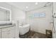 Bathroom featuring a freestanding tub, shower, and white subway tiles at 3008 S Church Ave, Tampa, FL 33629