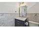 Bathroom boasts stylish vanity with navy cabinets, marble tile and modern fixtures at 3008 S Church Ave, Tampa, FL 33629