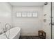 Bathroom featuring a freestanding tub, shower, and white subway tiles at 3008 S Church Ave, Tampa, FL 33629