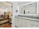 Main bathroom featuring double vanities, granite countertops, and an LED mirror at 3008 S Church Ave, Tampa, FL 33629