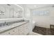Elegant bathroom featuring double sinks, sleek marble countertops, and a glass-enclosed shower at 3008 S Church Ave, Tampa, FL 33629