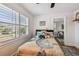 Bright bedroom boasts a ceiling fan, light walls, window with blinds, and decorative bed at 3008 S Church Ave, Tampa, FL 33629