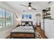 Bedroom with ceiling fan, light walls, and a rustic-themed bed is showcased at 3008 S Church Ave, Tampa, FL 33629