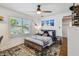 Bedroom with ceiling fan, light walls, and a rustic-themed bed is showcased at 3008 S Church Ave, Tampa, FL 33629