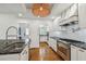 Modern kitchen featuring white cabinets, stainless steel appliances, hardwood floors, and a subway tile backsplash at 3008 S Church Ave, Tampa, FL 33629