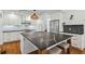 This kitchen features stainless steel appliances, white subway tile backsplash, and a large island at 3008 S Church Ave, Tampa, FL 33629
